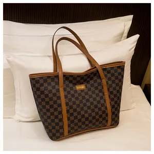 Detail of checkered tote bag with tan leather trim and Fashion & Bags front label