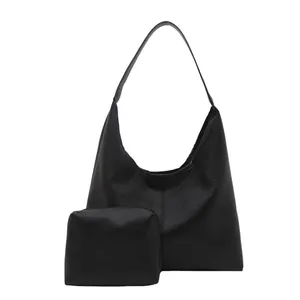 Minimalist black soft leather tote bag with small zipper pouch and large capacity design