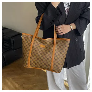 Close-up of brown vintage tote bag with geometric patterns and leather straps for work