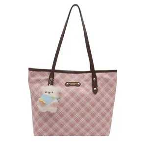 Pink checkered high-capacity tote bag with brown leather handles and bear pendant
