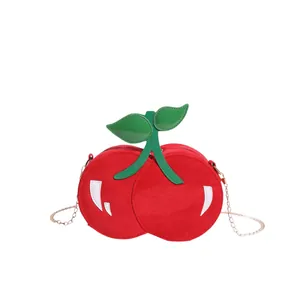 Creative cherry-shaped crossbody bag with red suede texture and gold chain strap