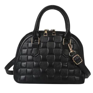 Quilted black dome handbag with gold hardware and removable shoulder strap for women