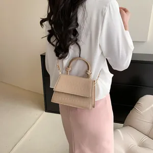 Chic beige crocodile texture crossbody bag with stylish circular knot handle for women