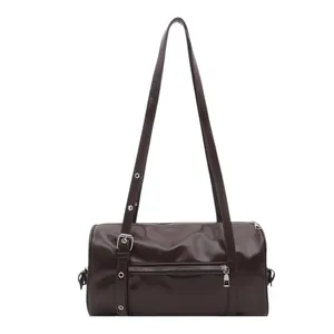 Dark brown glossy patent leather pillow shoulder bag with silver hardware on white background