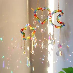 Close-up of three crystal suncatchers with gold metal frames creating rainbow light effects