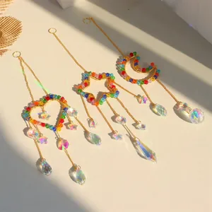 Detailed set of crystal suncatchers casting rainbow reflections on plain surface