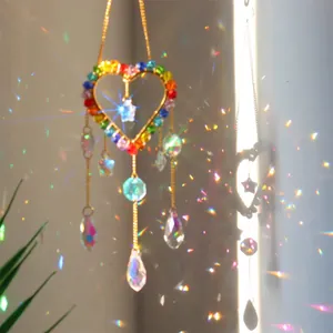 Detail of heart suncatcher with colorful beads and crystal pendants reflecting rainbow light