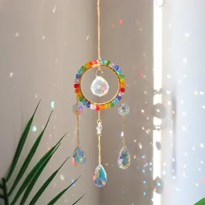 Detailed view of K9 crystal suncatcher with golden ring and rainbow prism light effect