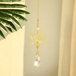 Detail of golden lotus suncatcher with amethyst stones and multifaceted crystal pendant