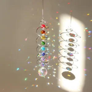 Detailed view of 3D spiral suncatcher with rainbow crystals and large faceted glass ball