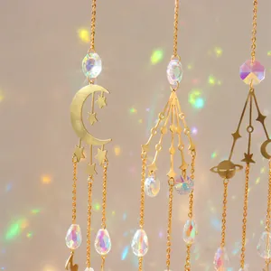 Detail of celestial crystal suncatchers casting rainbow light on a beige wall background