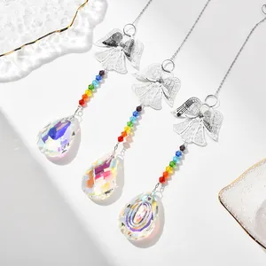 Detail of three crystal suncatchers with metal angels and colorful beads in a macro shot