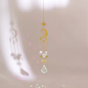 Macro detail of sun and moon crystal suncatcher reflecting rainbow light spots on wall