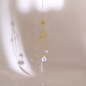 Macro shot of celestial sun and moon suncatcher with crystals casting rainbow reflections