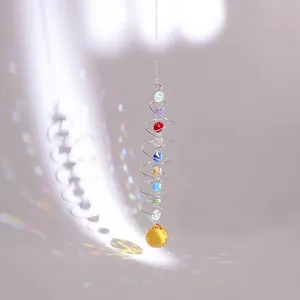 Detail of spiral suncatcher with rainbow beads and amber crystal ball prism