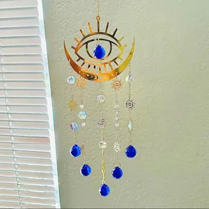 Detailed sun and moon suncatcher showing golden metal chains and blue crystal pendants