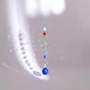 Detailed view of suncatcher with colorful beads and large blue crystal sphere
