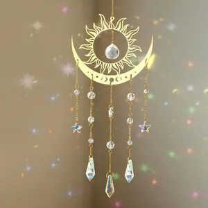 Detail of gold sun and moon suncatcher with rainbow crystal prisms and star charms