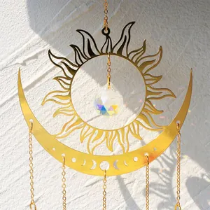 Detailed macro view of golden sun moon crystal suncatcher reflecting rainbow light on wall