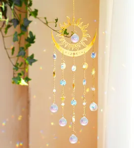 Detailed suncatcher with brass celestial moon sun motifs and colorful crystals in sunlight