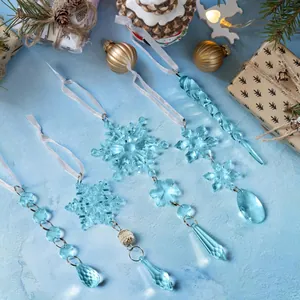 Macro shot of light blue acrylic snowflake and icicle ornaments with white ribbons