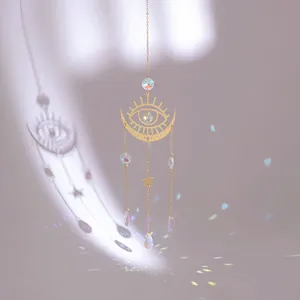 Golden moon and evil eye suncatcher with crystal beads casting rainbow reflections