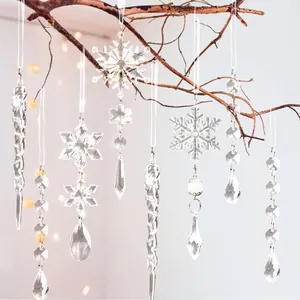 Close-up of clear acrylic snowflake and icicle ornaments hanging on a rustic branch