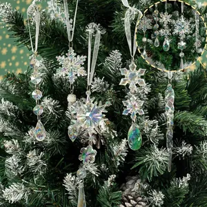 Close-up of iridescent acrylic snowflake and icicle ornaments hanging on a Christmas tree