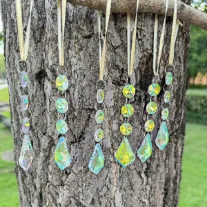 Detail of 6-piece crystal suncatchers with aurora finish hanging on a tree branch