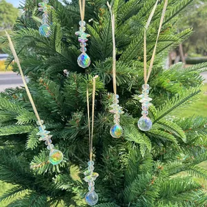 Detailed view of faceted crystal suncatchers hanging on pine branches for Christmas decor