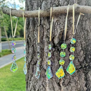Detailed view of 6-piece aurora crystal suncatchers with gold ribbons on tree branches