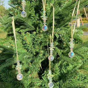 Macro shot of clear faceted crystal beads and sphere ornament hanging on a Christmas tree