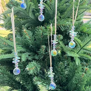 Set of 6 aurora crystal suncatchers hanging on green Christmas tree branches