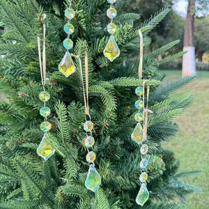 Detailed view of iridescent crystal suncatchers with multi-faceted leaf pendants