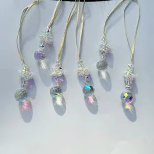 Detail of 5-piece crystal suncatchers with AB coating reflecting rainbows on white surface