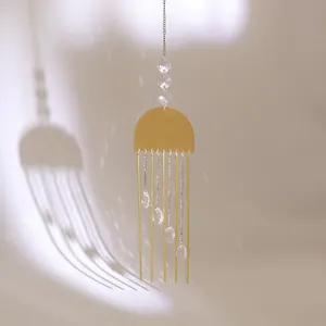 Natural rose quartz crystal wind chime with golden tubes and suncatcher crystals