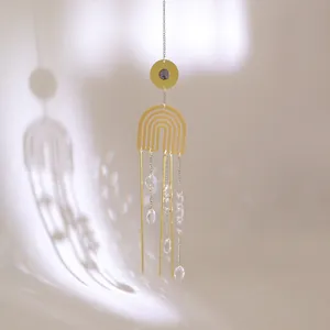 Detailed suncatcher view with crystal prisms casting shadows on a white wall