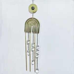 Detail of copper wind chime with natural rose quartz crystals and octagonal glass beads