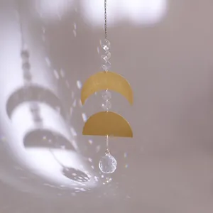 Golden brass moon suncatcher with natural crystals and rainbow light reflection