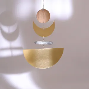 Golden suncatcher with brass crescent moon, wooden disk and natural crystal point