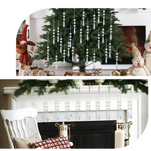 Detail of light blue teardrop crystal prisms hanging on a festive Christmas tree and fireplace