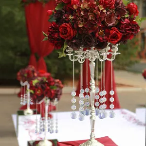 Detail of crystal glass pendants hanging from a silver floral candle holder stand