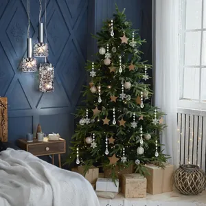 Close-up of sparkling crystal snowflakes and teardrop pendants on a decorated Christmas tree