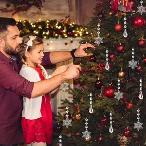 Family decorating Christmas tree with clear acrylic snowflake and teardrop crystal ornaments