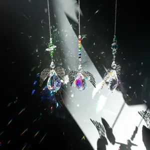 Three angel wing suncatchers with crystal prisms showing vibrant rainbow flare effects