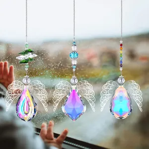 Macro detail of suncatcher crystals with hollow angel wings and colorful faceted beads