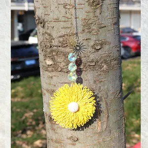 Handmade woven sunflower hanging decor with yellow petals and golden star pendant