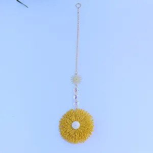 Macro shot of Bohemian woven sunflower pendant with crystal beads and golden sun metal piece