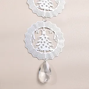 Detail of 3D metal wind spinner with Christmas tree cutout and faceted crystal teardrop