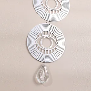 Detail of 3D stainless steel wind spinner with geometric eye and crystal pendant